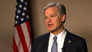 FBI Director Christopher Wray, Charged With Treason, Eludes JAG Dragnet